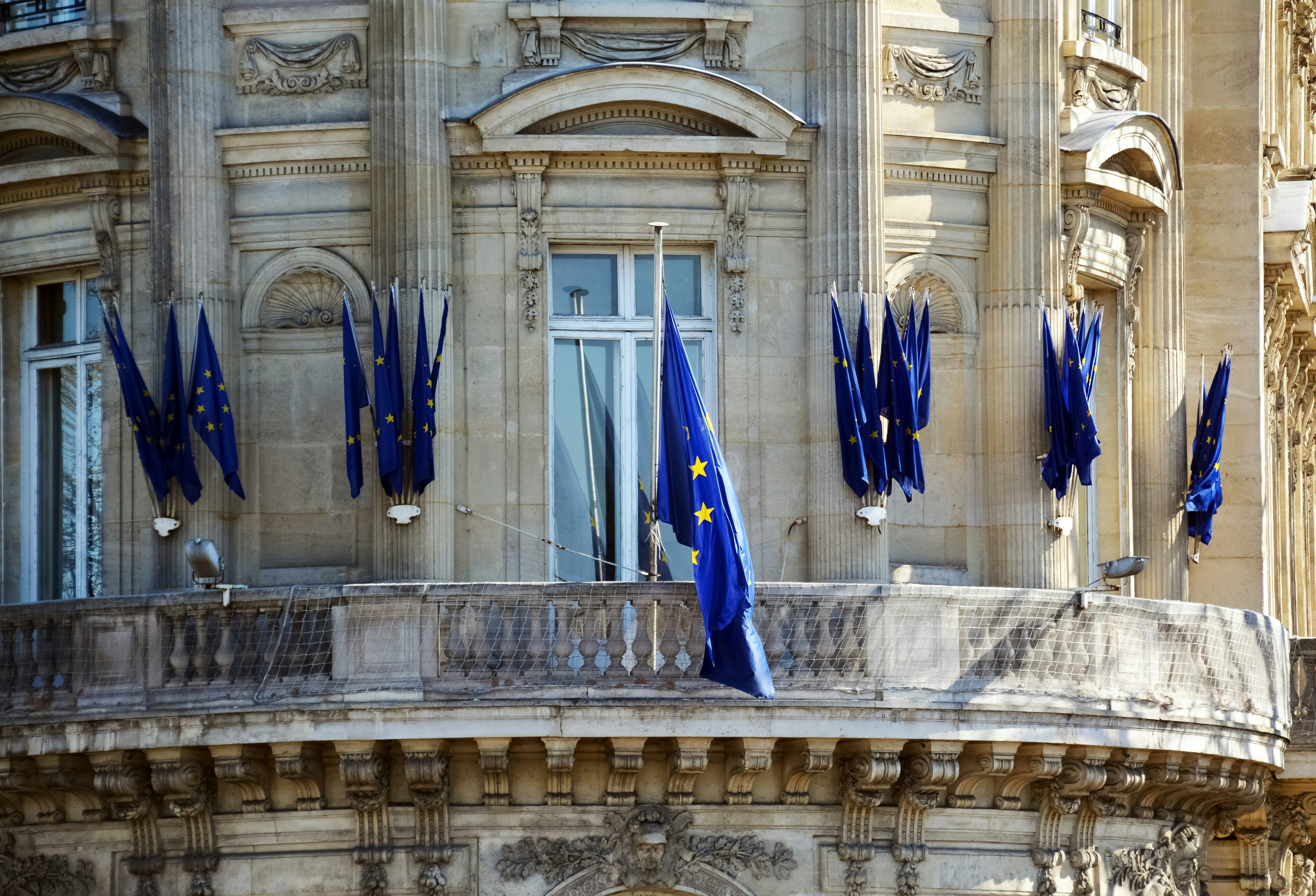 blue and yellow flag on white concrete building